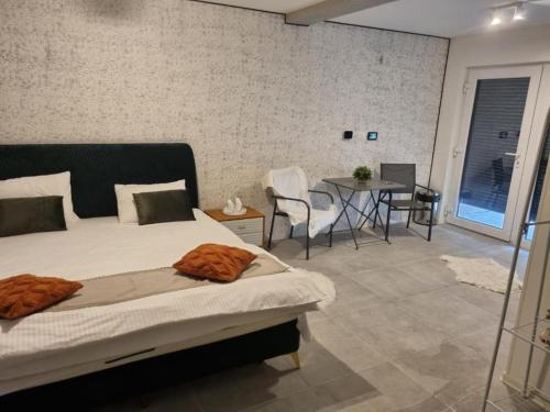 a bedroom with a bed and a table and chairs at Georgiana Apartments 2 in Timişoara