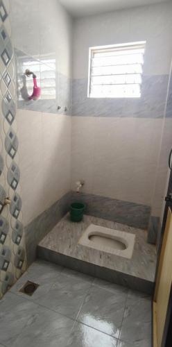 a bathroom with a toilet in the middle of it at Atithi Niwas, Best hotel near khandoba temple Jejuri in Jejūri