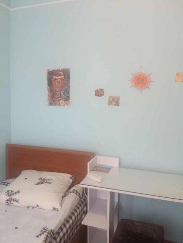 a small room with a bed and a desk at Guest House Armina in Yerevan