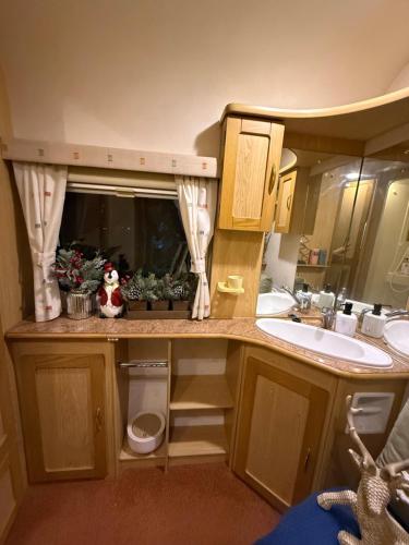 a small kitchen with a sink and a counter top at Samonrada Khao Yai Homestay in Pak Chong