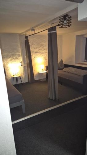 a bedroom with a bed and a bed and a window at Fridolin in Eichenbühl