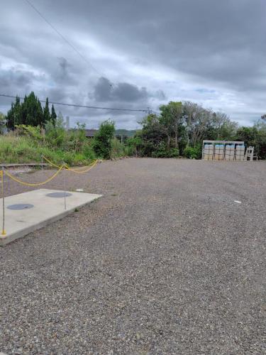 an empty parking lot with a yellow rope on it at 金島ハウス in Nishinoomote
