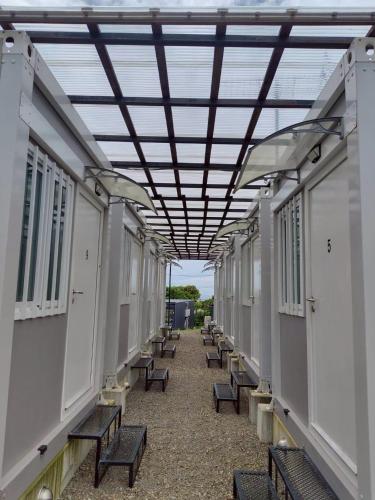 an empty corridor with benches in a building at 金島ハウス in Nishinoomote