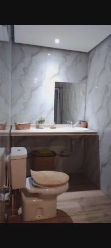 a bathroom with a toilet and a sink at Sal Blue Apartment in Santa Maria
