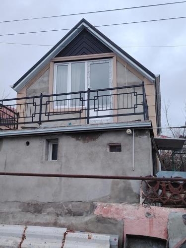 a house with a balcony on top of it at AGA Frame in Qusar