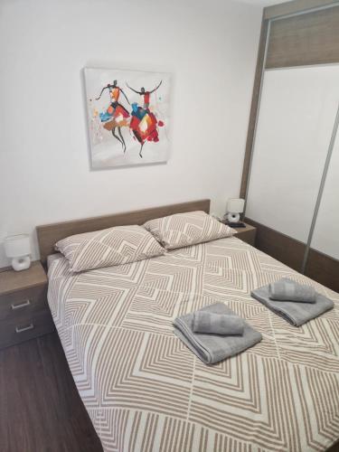 a bedroom with a bed with two towels on it at S + A in Posedarje