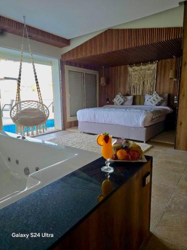 a room with a bed and a bathtub and a bedroom at Panorama Bungalows Resort El Gouna in Hurghada