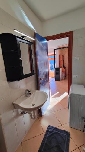 a bathroom with a sink and a view of a room at Casa Producena in Valdidentro