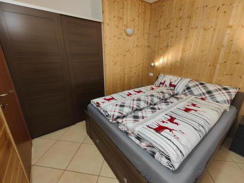 a bed in a room next to a door at Casa Producena in Valdidentro