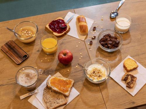 a wooden table topped with different types of breakfast foods at hotelF1 Bordeaux Ville in Bordeaux