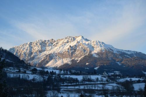 a snow covered mountain in the middle of a valley at Gästehaus Fuchs in Gröbming