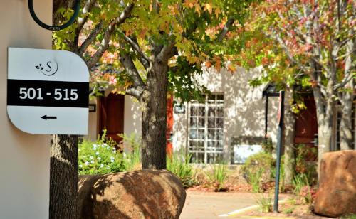 a sign on the side of a building next to a tree at Birchwood Hotel and OR Tambo Conference Centre in Boksburg