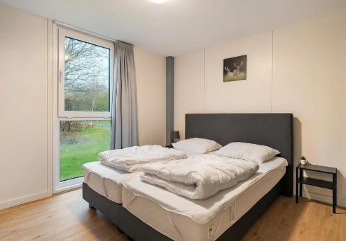 En eller flere senge i et værelse på Villa Juni - New spacious villa with hottub