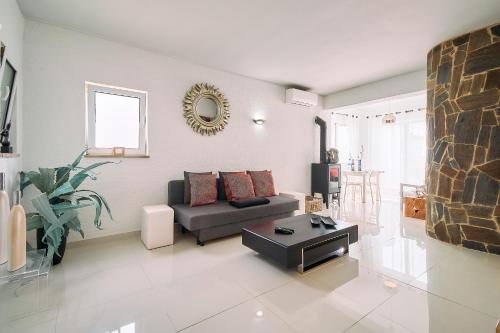 a living room with a couch and a table at Casa Beatriz in Carvoeiro