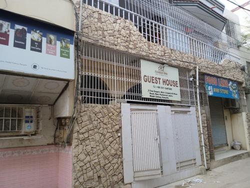 a building with a guest house on the side of it at Family Inn Guest House in Karachi