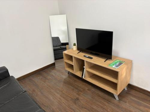 een woonkamer met een flatscreen-tv op een tafel bij Karü in Aluminé