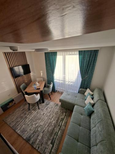 a living room with a couch and a table at Vikvid in Kopaonik