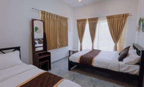 a bedroom with two beds and a window at Prithivee Homestay in Kotagiri