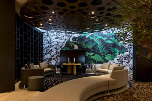 a lobby with a couch and chairs and a fireplace at Novotel RJ Praia de Botafogo in Rio de Janeiro