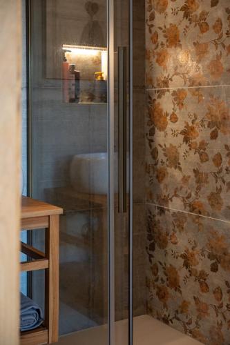 a shower with a glass door in a bathroom at CasettaLuce in Cuneo