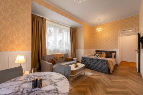 a living room with a couch and a table at Resort Červený dvůr - apartmány a wellness in Rapotín