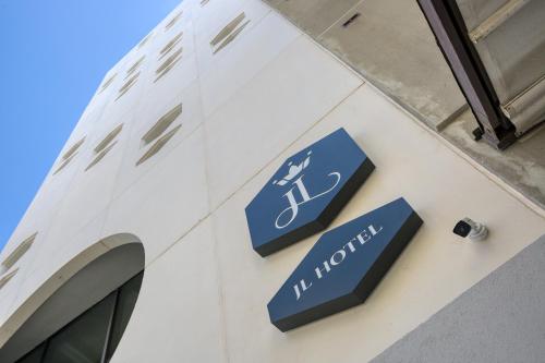 a blue sign on the side of a building at JL Hotel in St. Julianʼs