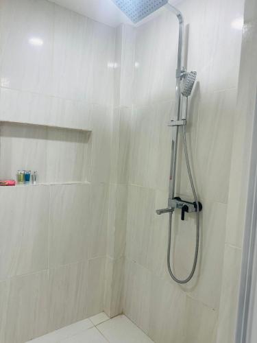 a shower with a shower head in a bathroom at AOS Rentals in Vreed en Hoop