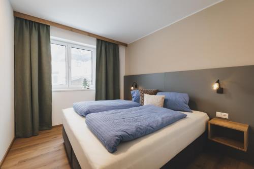 Postel nebo postele na pokoji v ubytování Dorfvilla Niedernsill