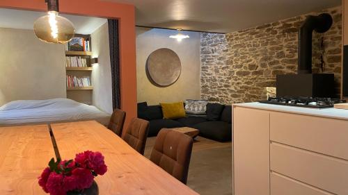 a kitchen and a living room with a table and a couch at La Saulzaie in L'Ile d'Yeu