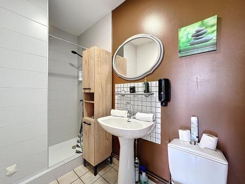 a bathroom with a sink and a toilet and a mirror at Unique, Chambre 2,centre équestre & snacks in Vic-le-Comte