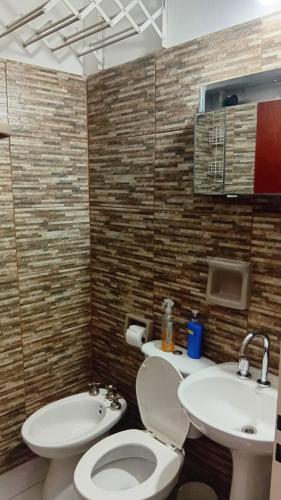 a bathroom with a toilet and a sink at Departamentos tini in La Punta