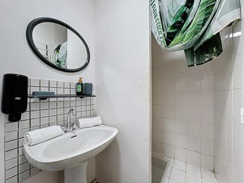 a white bathroom with a sink and a mirror at Unique Chambre 1 Centre Équestre Snack in Vic-le-Comte