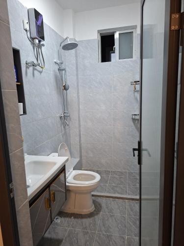 a bathroom with a toilet and a sink at Haven Place 254-near JKIA,SGR with Self-Check in & Free Parking in Nairobi