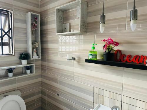 a bathroom with a toilet and a sink at Knovi Guesthouse in Bulawayo