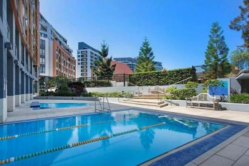 a large swimming pool in the middle of a building at Wolli Creek Entire 2-Bedroom apartment with 2 bathrooms in Sydney
