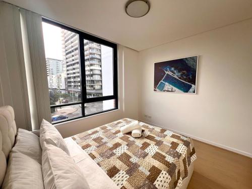 a bedroom with a bed and a large window at Wolli Creek Entire 2-Bedroom apartment with 2 bathrooms in Sydney