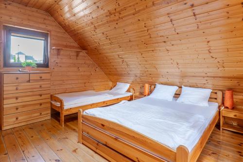 Postel nebo postele na pokoji v ubytování Kakadu domki letniskowe Niechorze