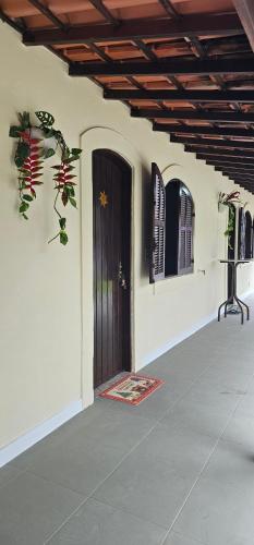 a front door of a house with a porch at Pousada Paraíso Guapi in Guapimirim