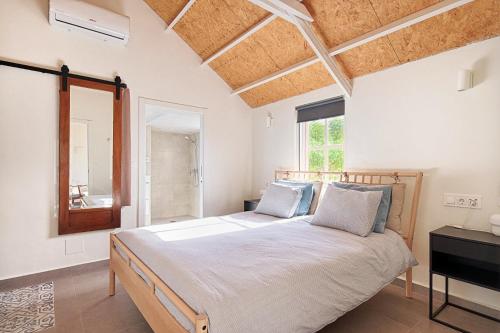 a bedroom with a large bed and a window at Casa Boletes, with splendid views! in Cartagena