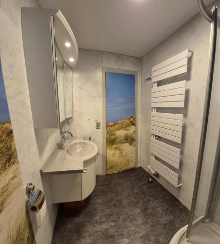 a bathroom with a sink and a toilet and a shower at IMMEUBLE Panorama in Les Collons