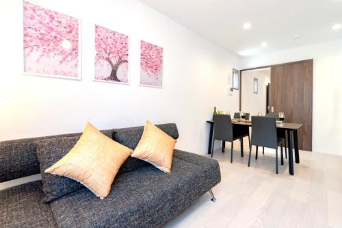 a living room with a couch and a dining room at sunshin dream in Osaka
