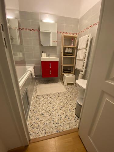 a bathroom with a tub and a sink and a toilet at Newly Renovated Ground Floor Apartment close to Thermes in Luchon