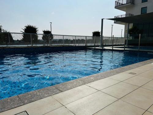 a swimming pool with blue water in front of a building at Ark Living Stay in Yas Island in Yas Island