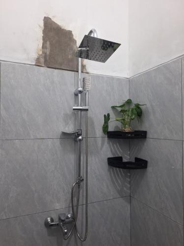 a shower with a shower head in a bathroom at Bromo Venture in Probolinggo