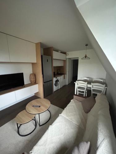 un salon avec un canapé et une table dans l'établissement Résidence du golf, à Deauville