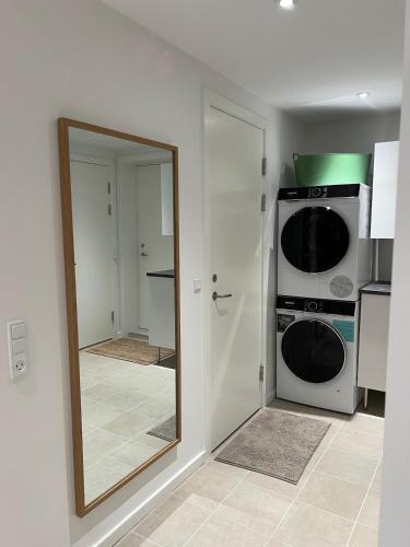 a mirror in a kitchen with a stove and a microwave at Private apartment with panoramic ocean views in Ilulissat