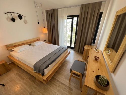 a bedroom with a bed and a table in it at The Bay View Hotel Kalkan in Kaş