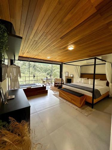 a bedroom with a large bed and a large window at Cabana Terra Nossa com vista in Marechal Floriano