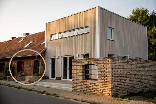 a brick house with a large mirror in front of it at Apartment mit Connection am Müritz National Park 