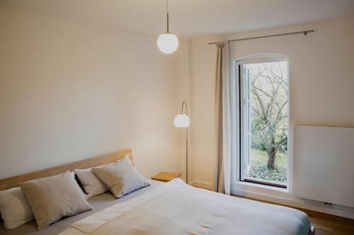 a bedroom with a bed with a large window at Apartment mit Connection am Müritz National Park 